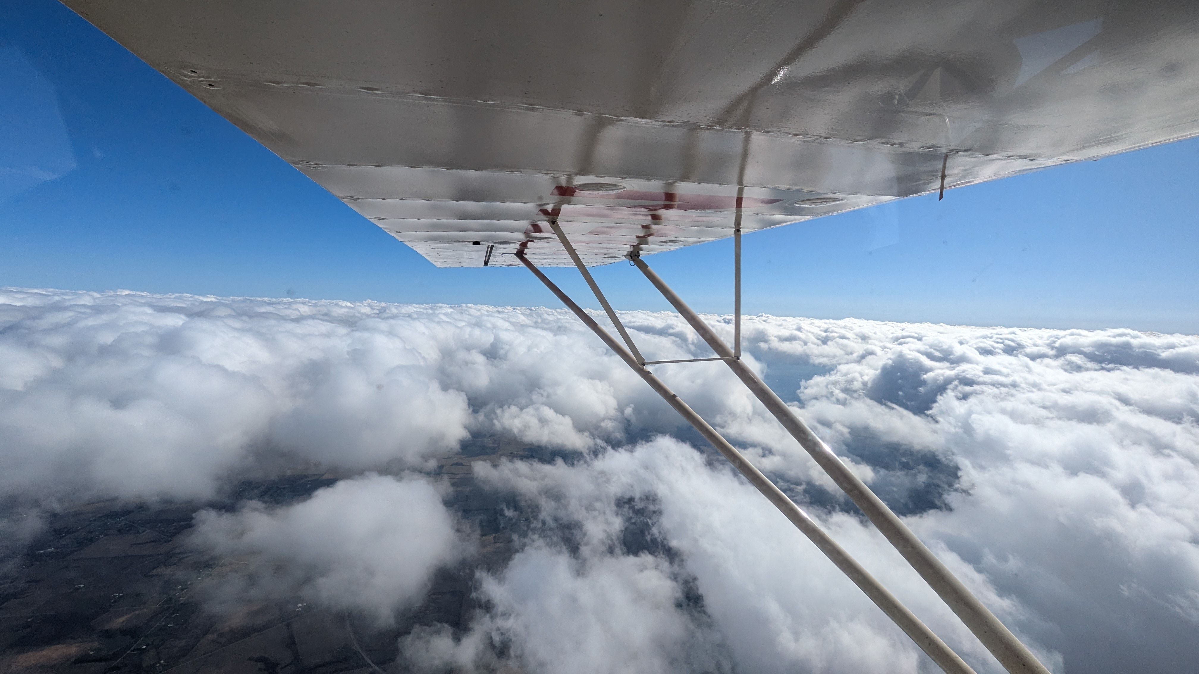 View from a general aviation cockpit above the clouds